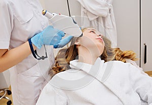 procedure of hardware skin rejuvenation using a cold stream of carbon dioxide CO2. A cosmetologist performs a skin