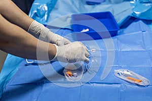 The procedure of inserting a double lumen catheter into a patient with cardiovascular occlusion in the hospital. Doctor insert