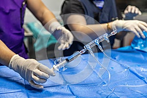 The procedure of inserting a double lumen catheter into a patient with cardiovascular occlusion in the hospital. Doctor insert