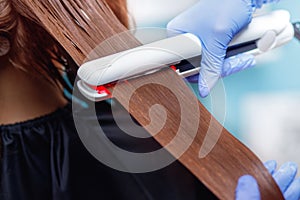 Procedure of keratin hair straightening and restoration photo