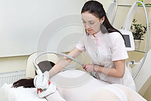 The procedure of lipomassage in a beauty salon