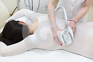 The procedure of lipomassage in a beauty salon