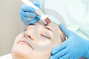 Procedure of medical micro needle therapy with a modern medical instrument derma roller