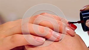 The procedure of painting nails in the spa salon.Manicure procedure in the beauty salon.Spa manicure procedure