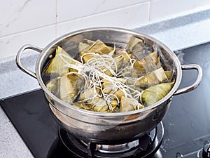 Procedure step of making zongzi or rice dumpling recipe, steam and boil on Dragon Boat Festival