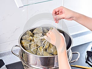 Procedure step of making zongzi or rice dumpling recipe, steam and boil on Dragon Boat Festival