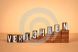 Procedure word in German. Wooden alphabet letters on a light background