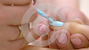 Process of applying polish on female nail.