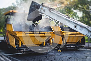 Process of asphalting, blacktopping and paving, asphalt paver machine and steam roller compactor during construction and repairing