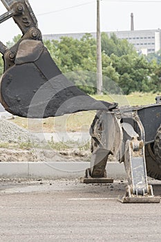 The process of asphalting roads. Machinery for asphalting roads. vertical photo