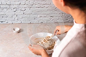 Process of baking health bread at home. closeup woman hands kneading dough from rye flour on marble countertop in bright kitchen