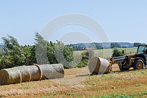 The process of baling straw with balers. Modern technology.