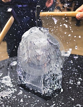 Process of breaking the ice with hammer and ice pick, group of people smashing shattered ice cube, team work success concept,