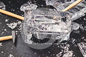 Process of breaking the ice with hammer and ice pick, group of people smashing shattered ice cube, team work success concept,