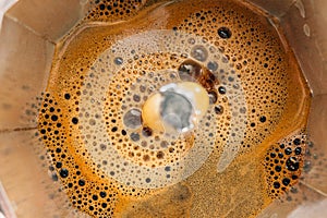 Process of brewing coffee in a moka pot, close-up, top view