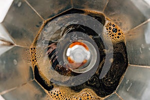 Process of brewing coffee in a moka pot, close-up, top view