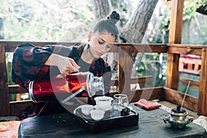 Process brewing tea. Woman steeping herbal tea