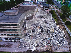A process of buliding demolition, demolished house, shot from air with drone photo
