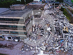A process of buliding demolition, demolished house, shot from air with drone photo