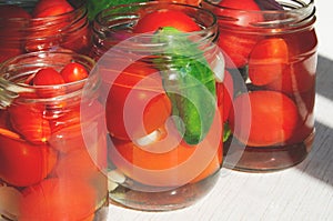 The process of canning pickled tomatoes and cucumbers for the winter