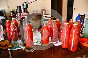process of capping sauce bottles photo