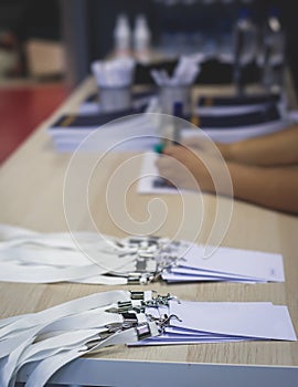 Process of checking in on a conference congress forum event, registration desk table, visitors and attendees receiving a name