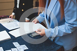 Process of checking in on a conference congress forum event, registration desk table, visitors and attendees receiving a name