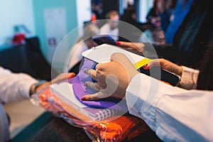 Process of checking in on a conference congress forum event, registration desk table, visitors and attendees receiving a name