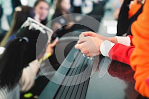 Process of checking in on a conference congress forum event, registration desk table, visitors and attendees receiving a name