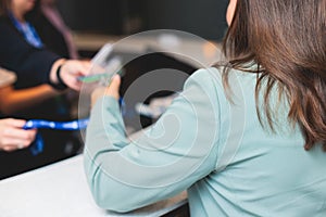 Process of checking in on a conference congress forum event, registration desk table, visitors and attendees receiving a name