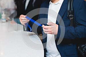 Process of checking in on a conference congress forum event, registration desk table, visitors and attendees receiving a name