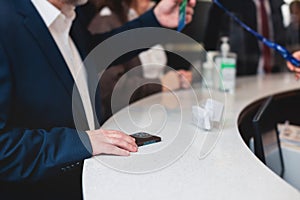 Process of checking in on a conference congress forum event, registration desk table, visitors and attendees receiving a name