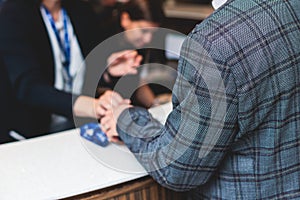 Process of checking in on a conference congress forum event, registration desk table, visitors and attendees receiving a name