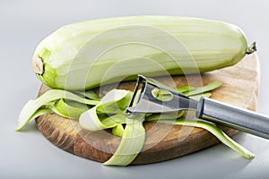 Process of cleaning raw squash with a vegetable peeler