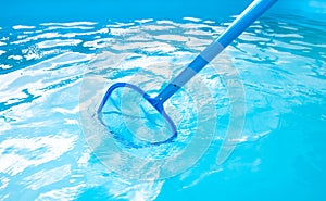 Process of cleaning swimming pool by a hand net during summer time season