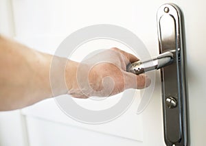 The process of clicking on the handle to open the door photo