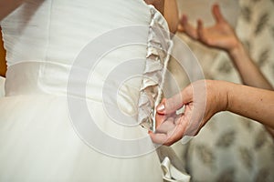 Process of clothing on a wedding dress.