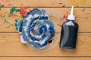 The process of coloring T-shirts in tie dye style in blue tones. Flat lay