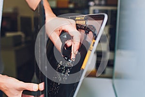 Process of computer repair. Engineer in white gloves disassembling computer.