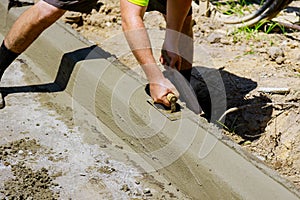 The process of construction of the sidewalk, the installation of a curb