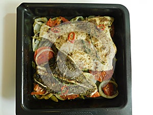 the process of cooking flounder with herbs, onions, tomatoes and white wine