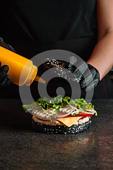 Process of cooking hamburger. chef on the kitchen table making out the ingredients of the Burger. Beef Patty cooked on