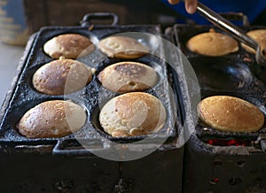 The process of cooking Kue Apem, an Indonesian traditional cake on street food market, in Yogyakarta, Indonesia