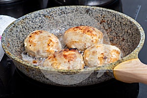 The process of cooking in a pan with fried meat, meatballs, barbecue. Fast Food concept - closeup of cutlets