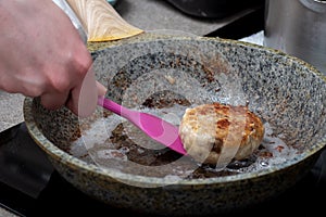 The process of cooking in a pan with fried meat, meatballs, barbecue. Fast Food Concept - Closeup of Cutlets