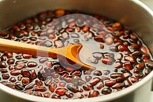 The process of cooking pine nuts in order to become softer than the shell
