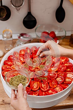 The process of cooking sun-dried tomatoes.