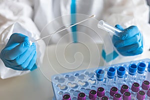 Process of coronavirus PCR antigen testing examination by nurse medic in laboratory lab, COVID-19 swab collection kit, test tube