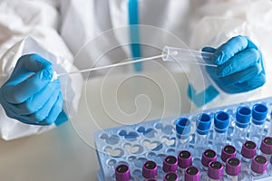 Process of coronavirus PCR antigen testing examination by nurse medic in laboratory lab, COVID-19 swab collection kit, test tube