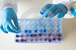 Process of coronavirus PCR antigen testing examination by nurse medic in laboratory lab, COVID-19 swab collection kit, test tube